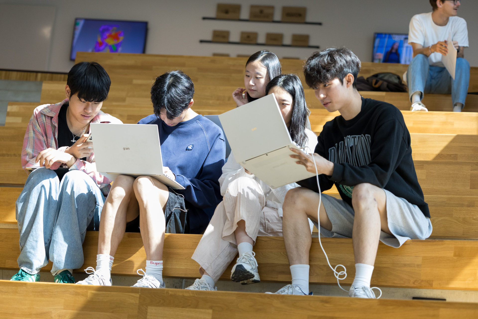 Students collaborating on laptops during an on-site week